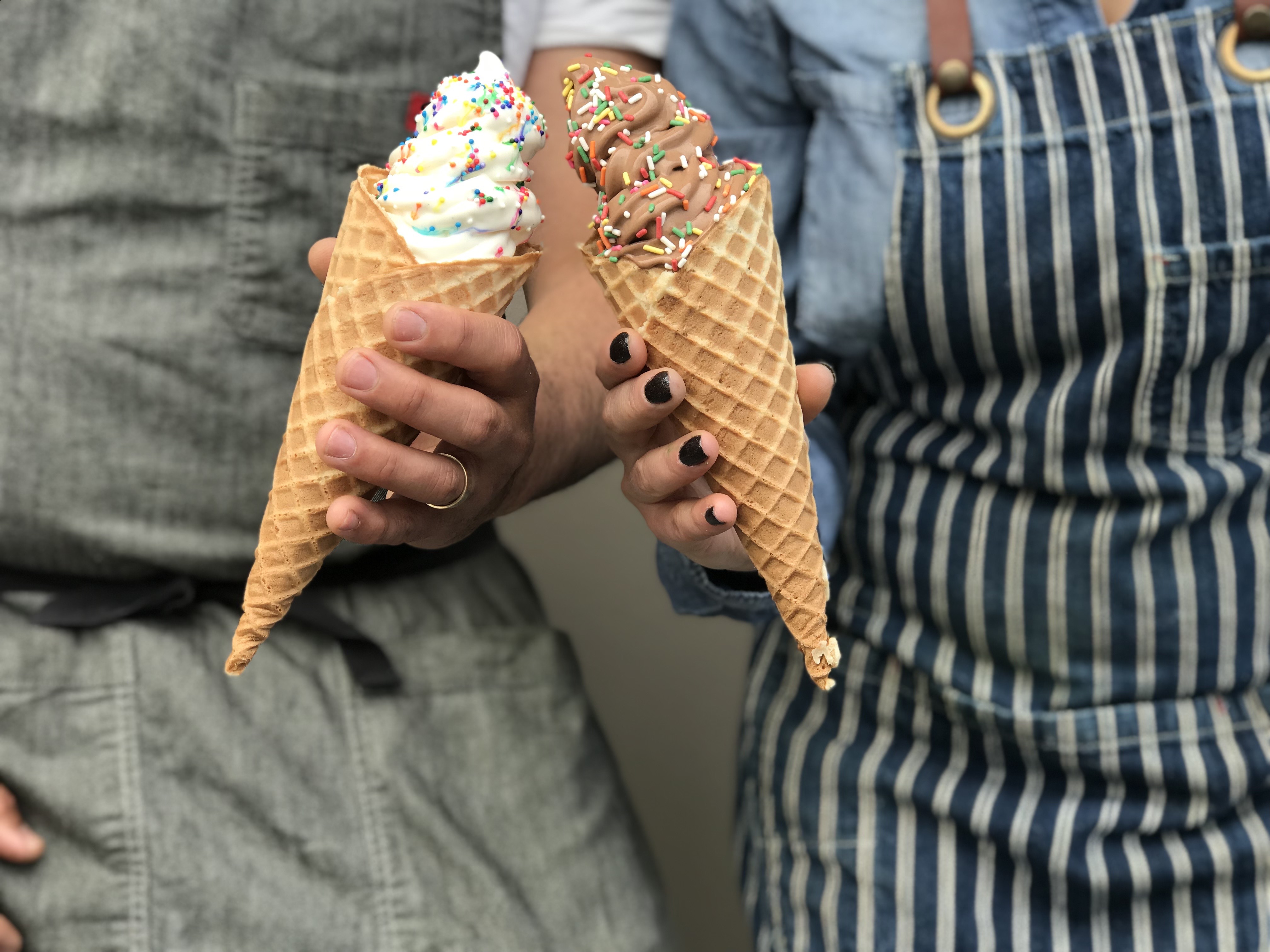 Two people hold ice cream cones at Sugarpine.